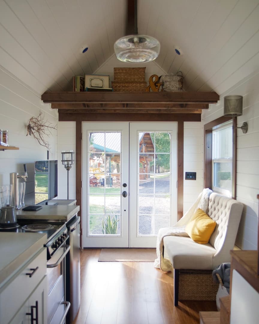 White french doors showing outside. Photo by Instagram user @tinyheirloom