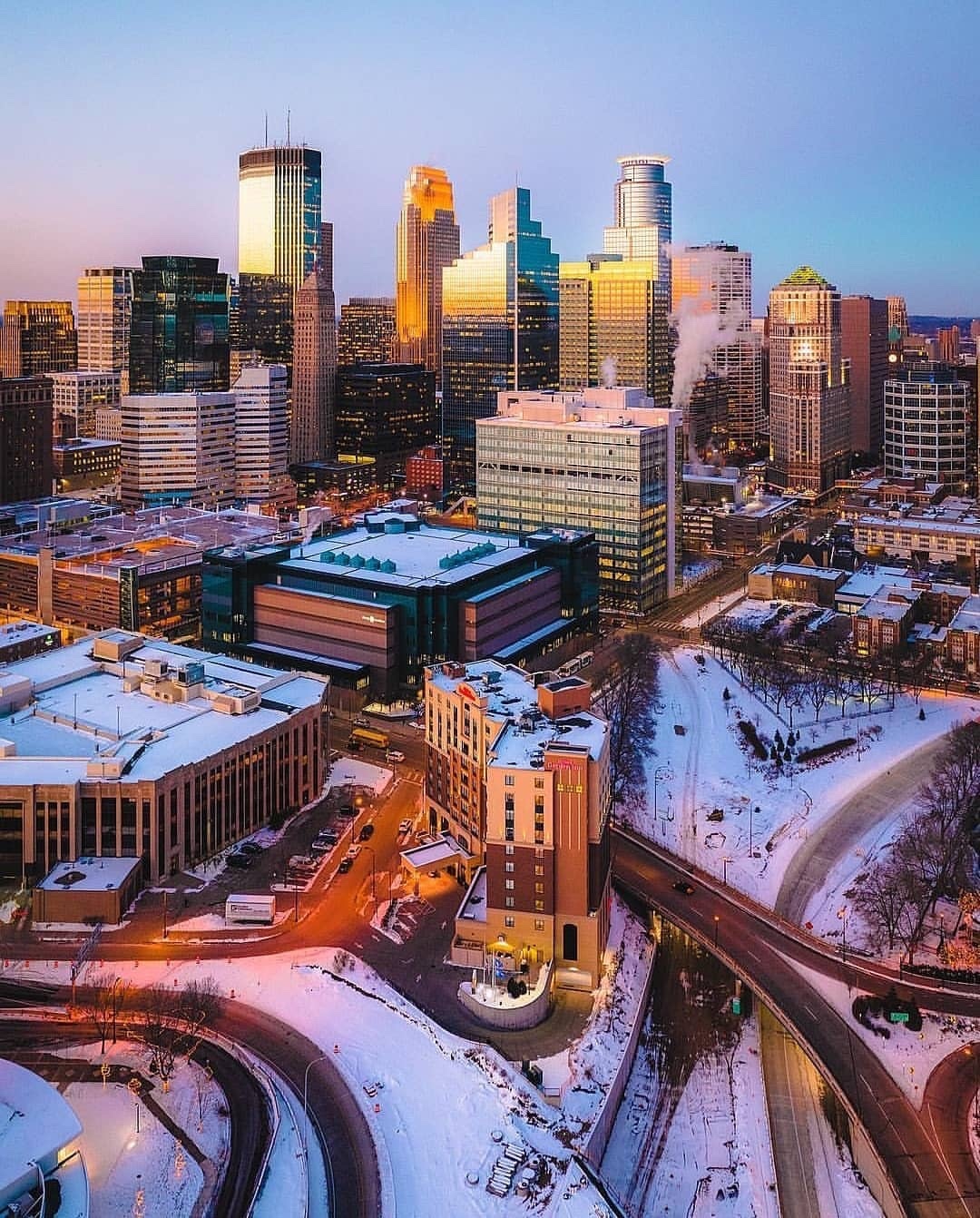 Tall buildings at night in Downtown Minneapolis during winter. Photo by Instagram user @travelmoretwincities