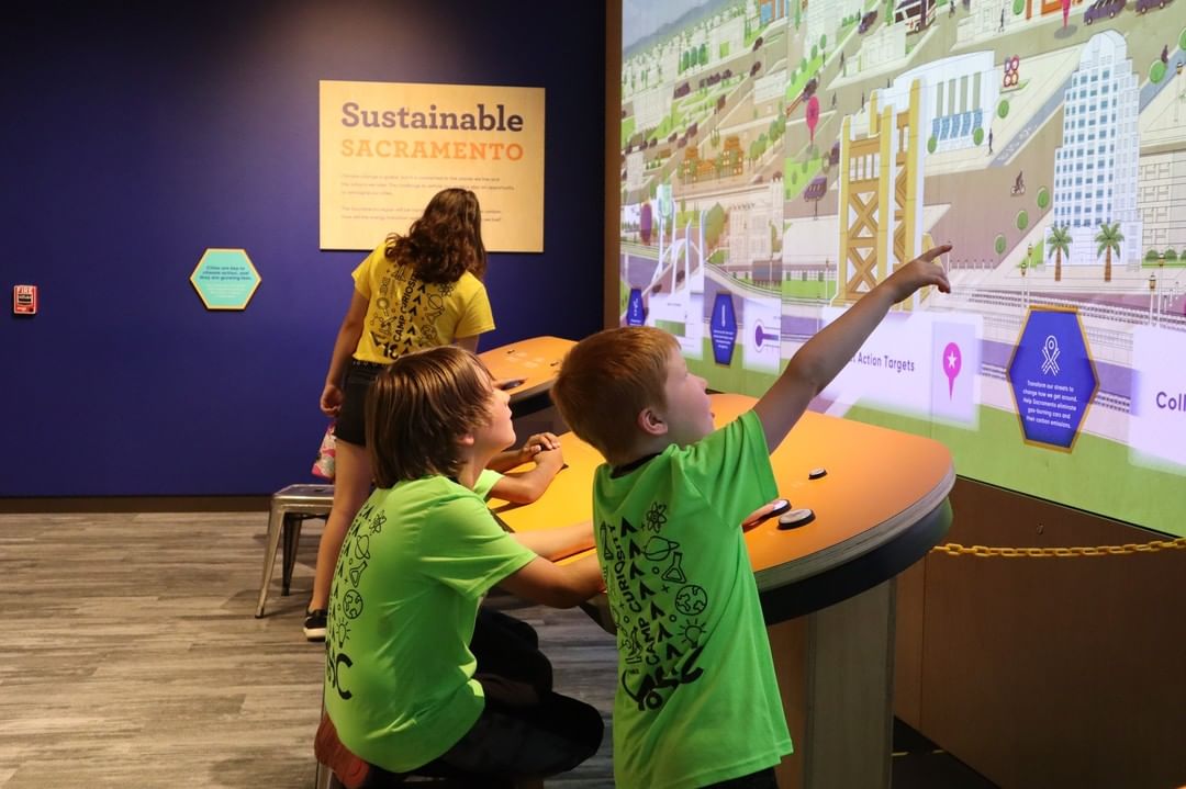 Two children interacting with an exhibit at the MOSAC museum. Photos by Instagram user @smud_mosac.