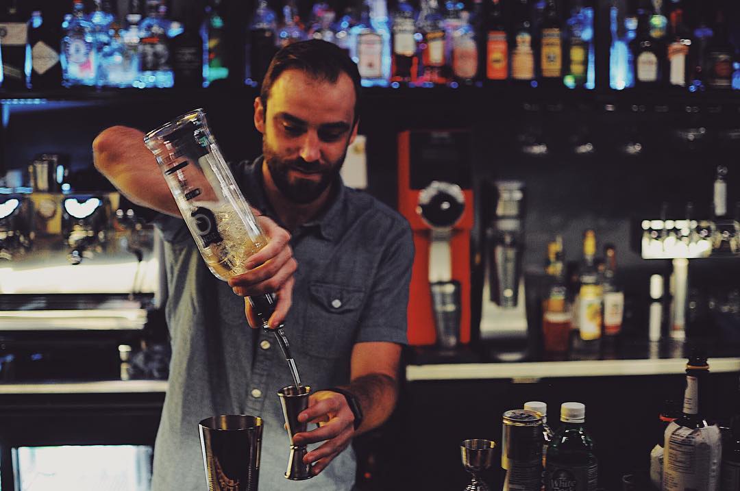 Bartender pouring a cocktail. Photo by Instagram user @ponyboyokc