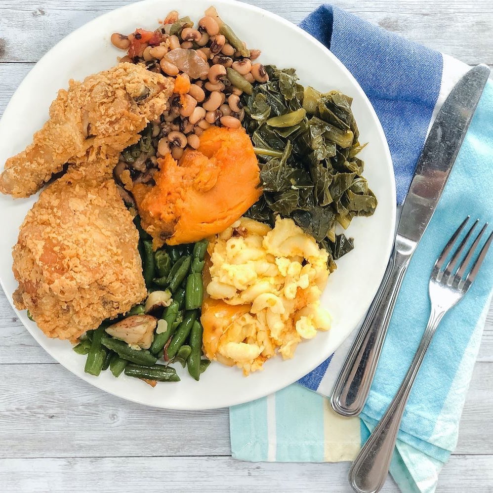 Plate of fried chicken on a wooden table. Photo by Instagram user @theladyandsons