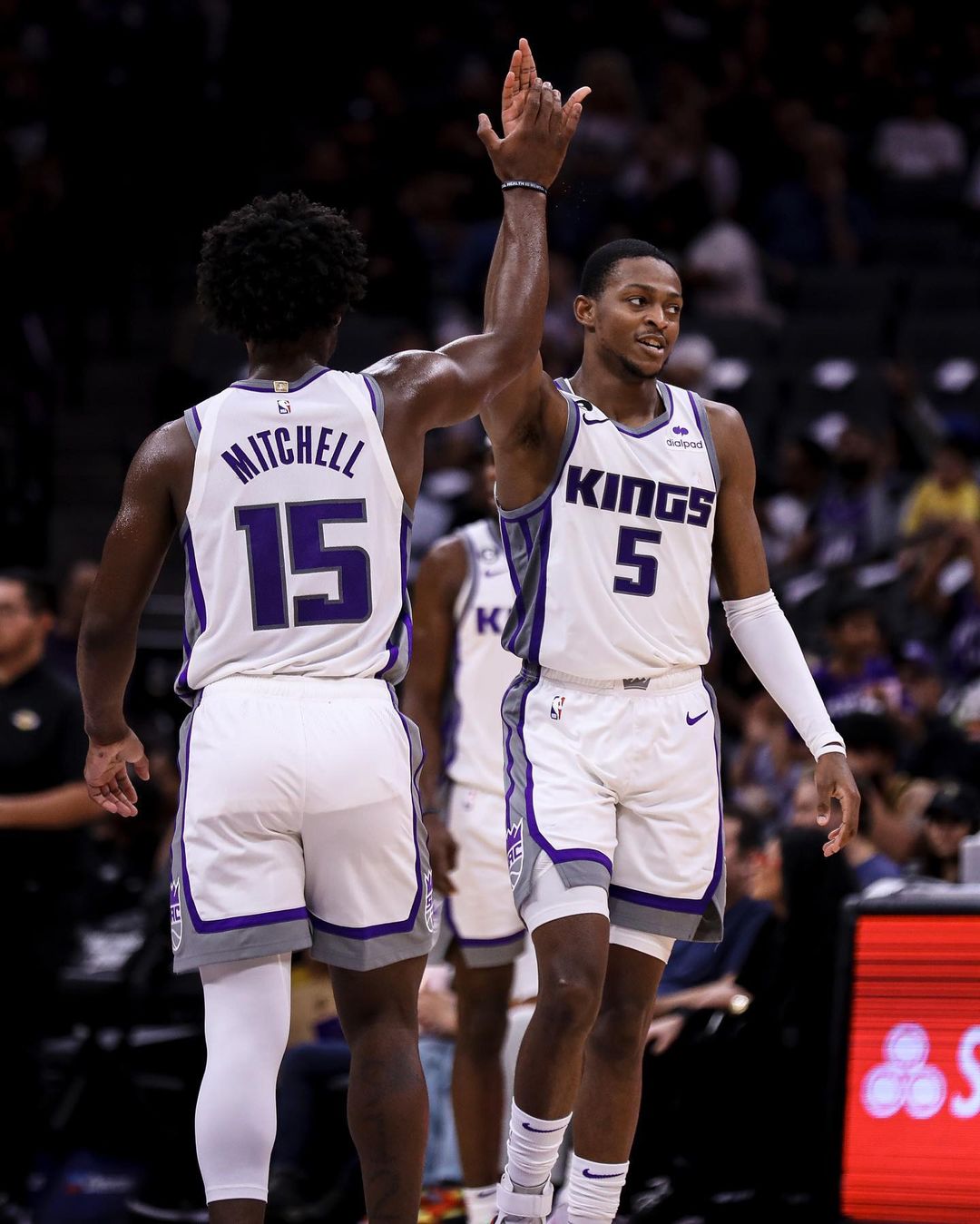 Two members of the Sacramento Kings high-fiving on the basketball court. Photo by Instagram user @sacramentokings.