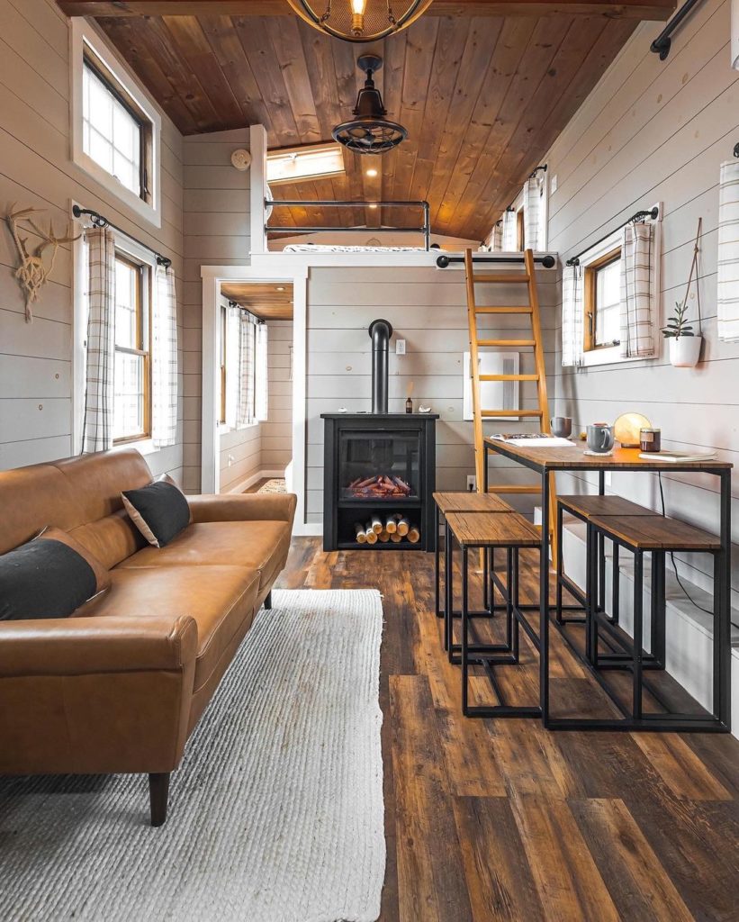 tiny home with wooden accents and ladder stairs. photo via Instagram user @ethanabitz