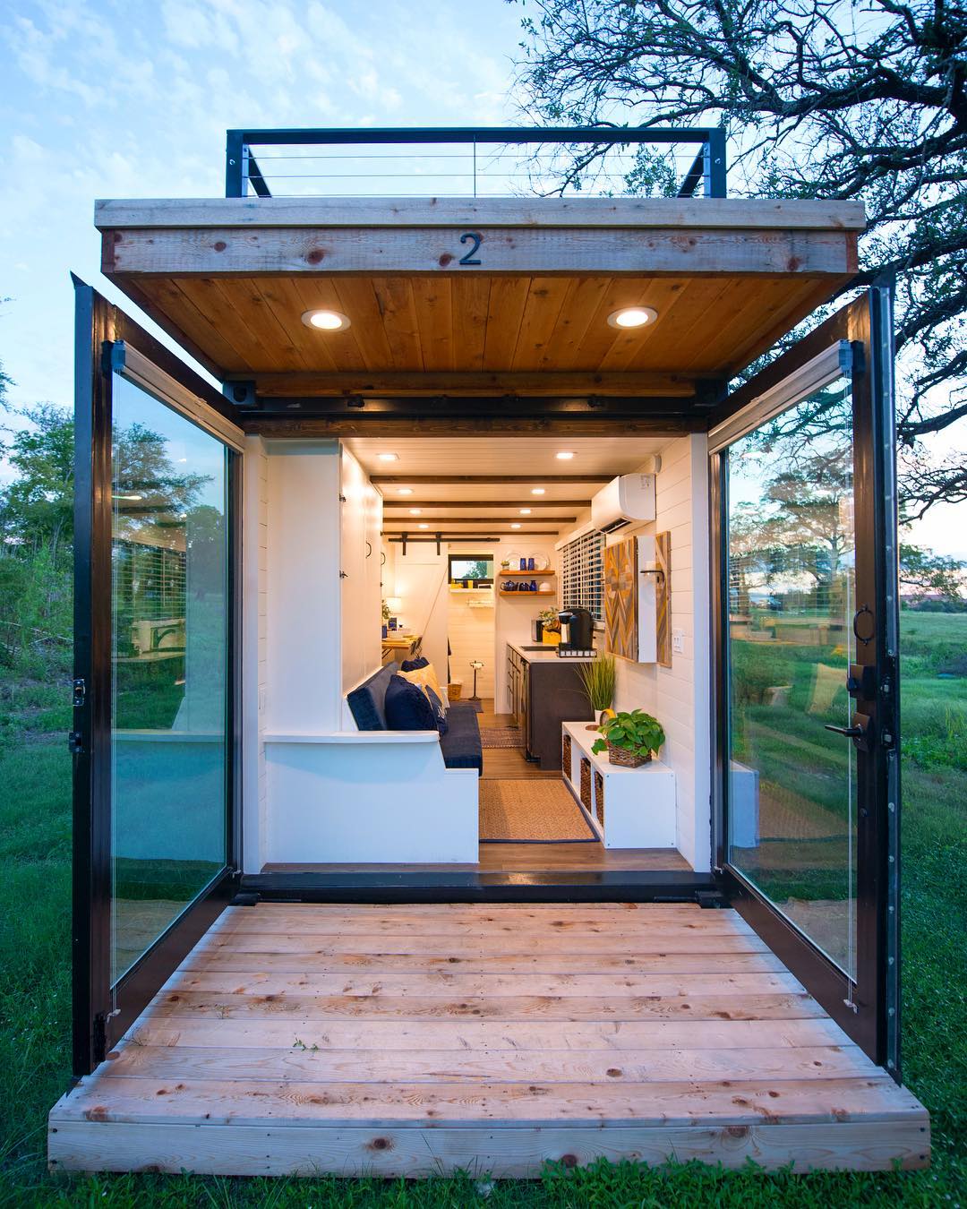 Tiny home porch with giant glass doors. Photo by Instagram user @cargo_home