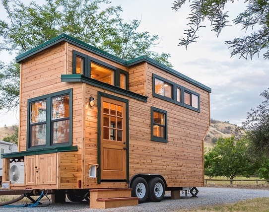 wooden tiny home with black windows photo via @californiatinyhouse