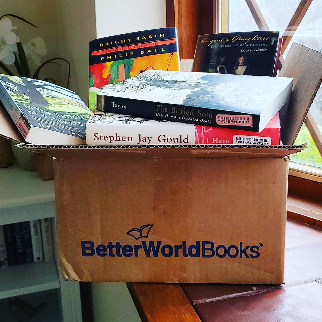 Cardboard box of books. Photo by Instagram user @abookolive