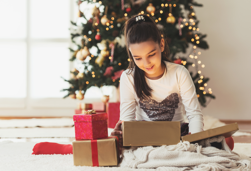 Young girl opening presents