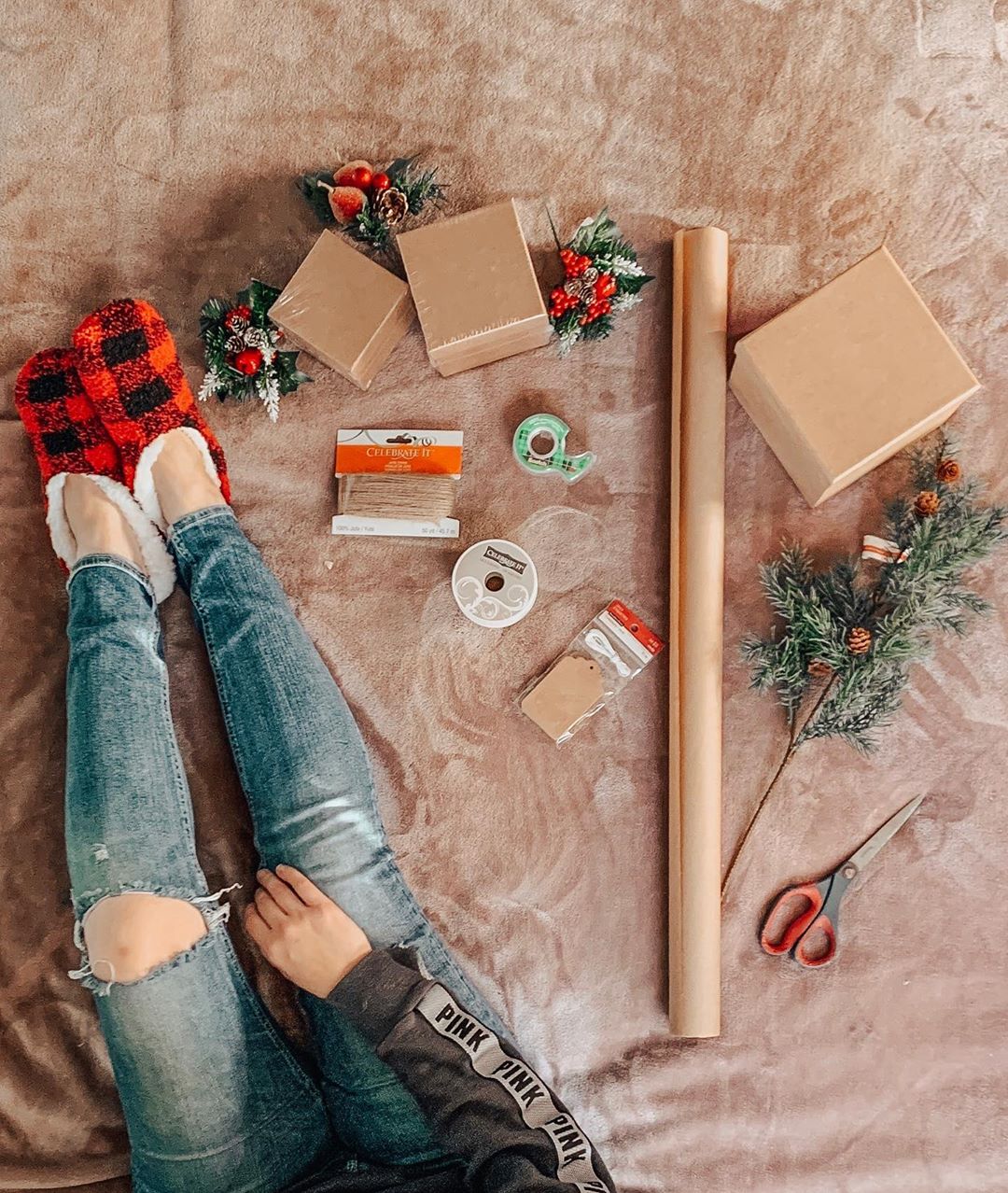 Girl in jeans wrapping presents. Photo by Instagram user @thisiscaitk
