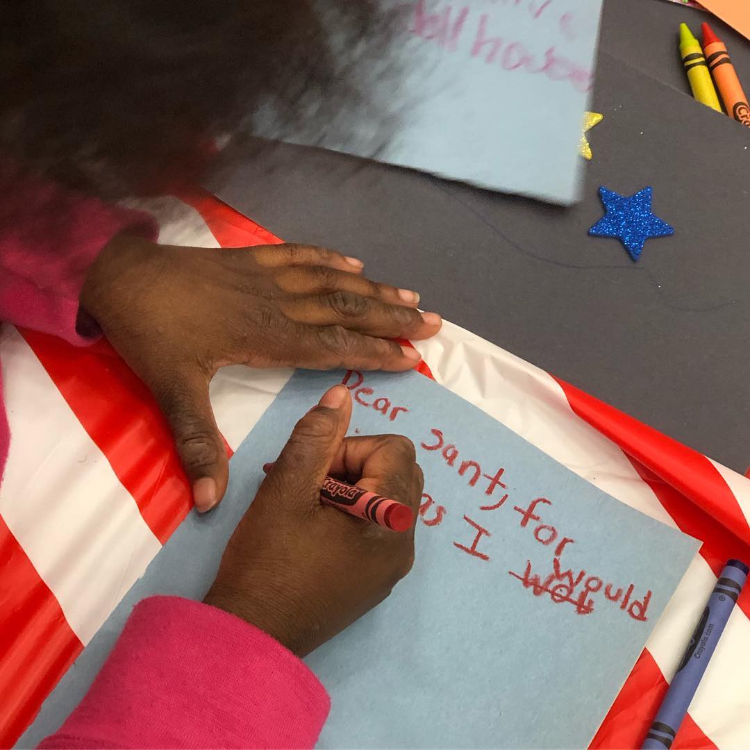 Girl writing letter to Santa. Photo by Instagram user @onesimplewish