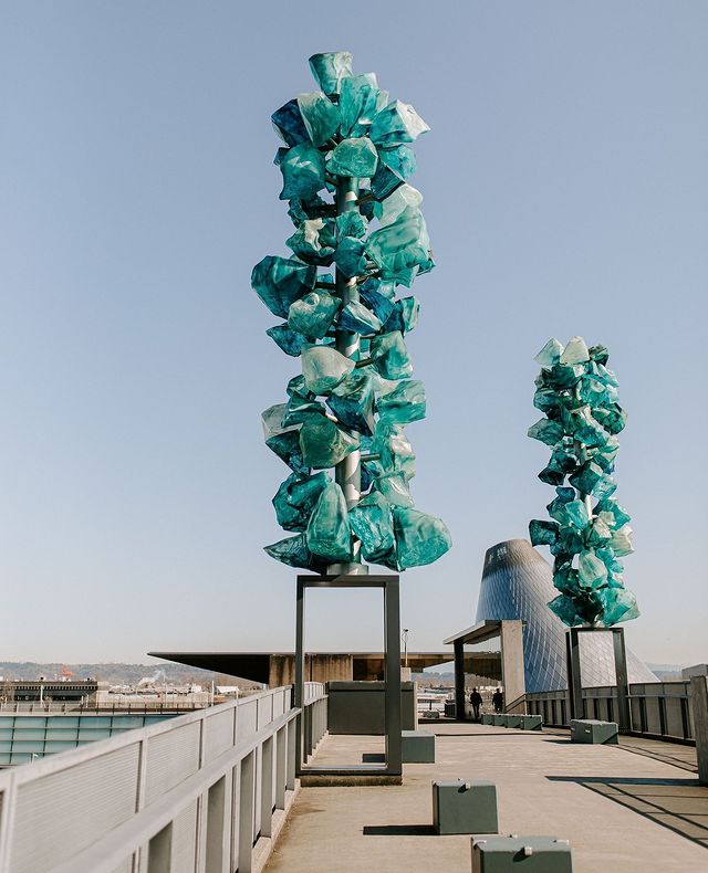 Two blue blown glass sculptures under a cloudless sky. Photo by Instagram user @provenancehotels.