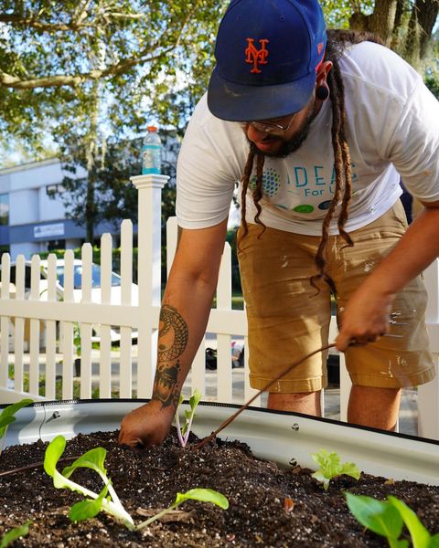 Close up of a gardener tending plants.