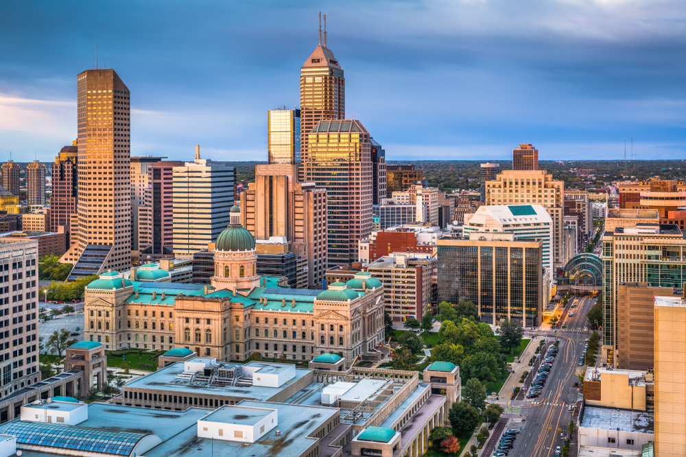 Skyline of tall buildings in Downtown Indianapolis at sunset.