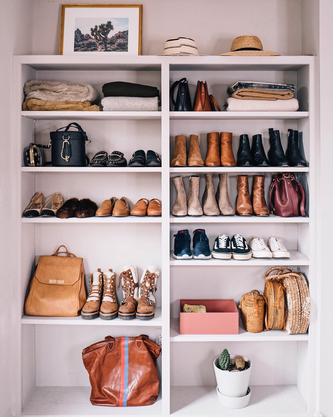 Boots and clothes sitting on white shelves. Photo by Instagram user @jessannkirby