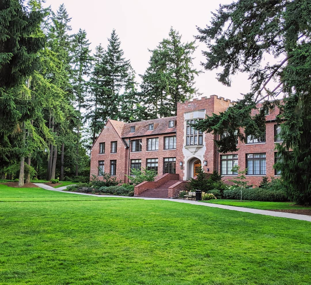 Red brick buildings by green lawn at University of Puget Sound. Photo by Instagram user @ekelly80