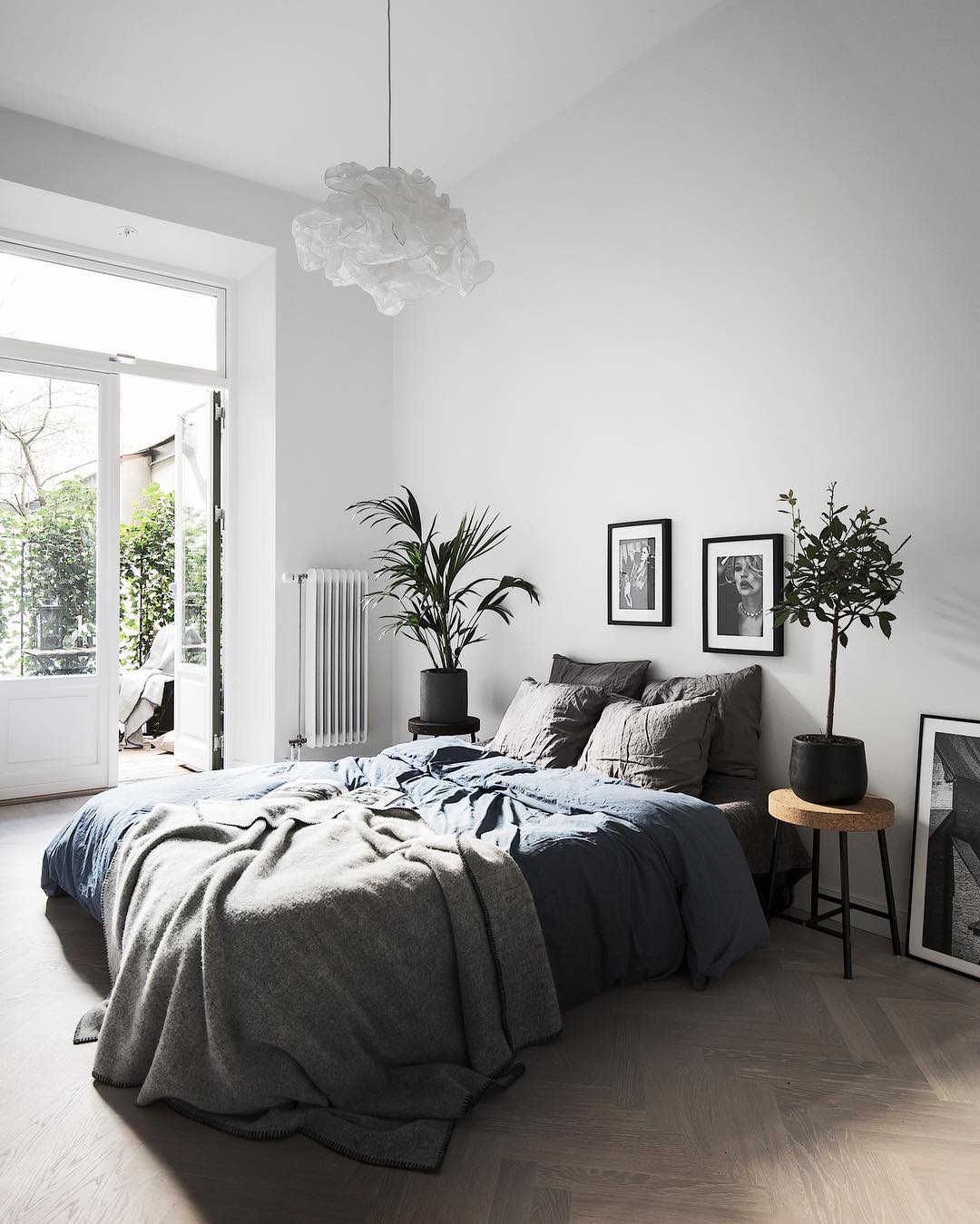 Gray bedroom with dark gray bed. Photo by Instagram user @kronfoto