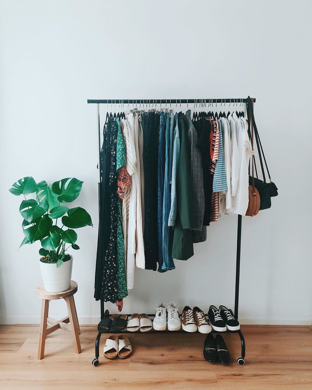 Clothes hanging on a rolling rack. Photo by Instagram user @selinasinspiration