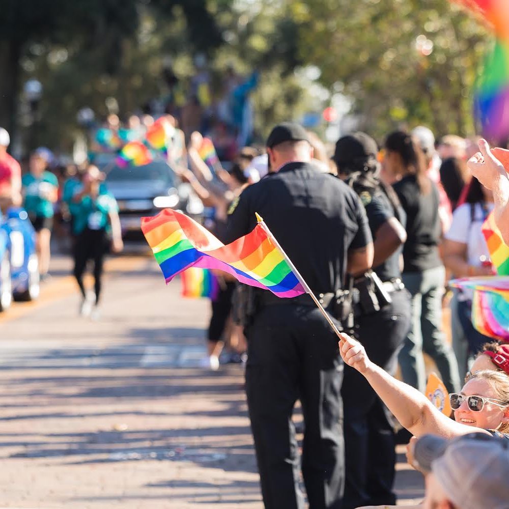 People holding rainbow flags at parade. Photo by Instagram user @comeoutwithpride