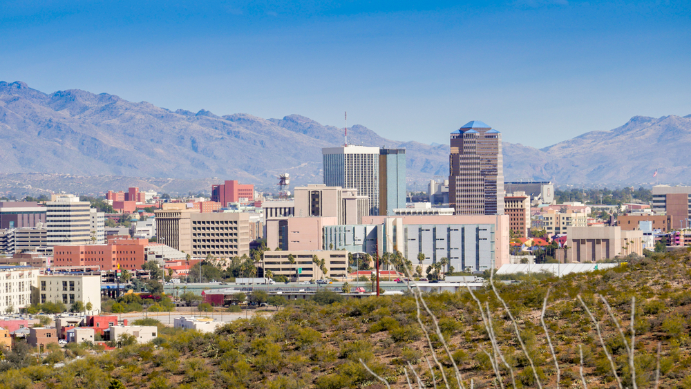 Skyline of tall buildings surrounded by mountains in Tucson.