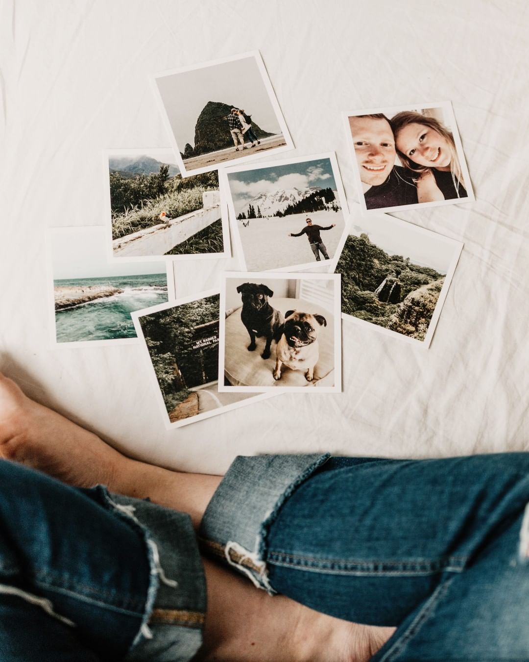 Pictures scattered on a bed. Photo by Instagram user @surround_us