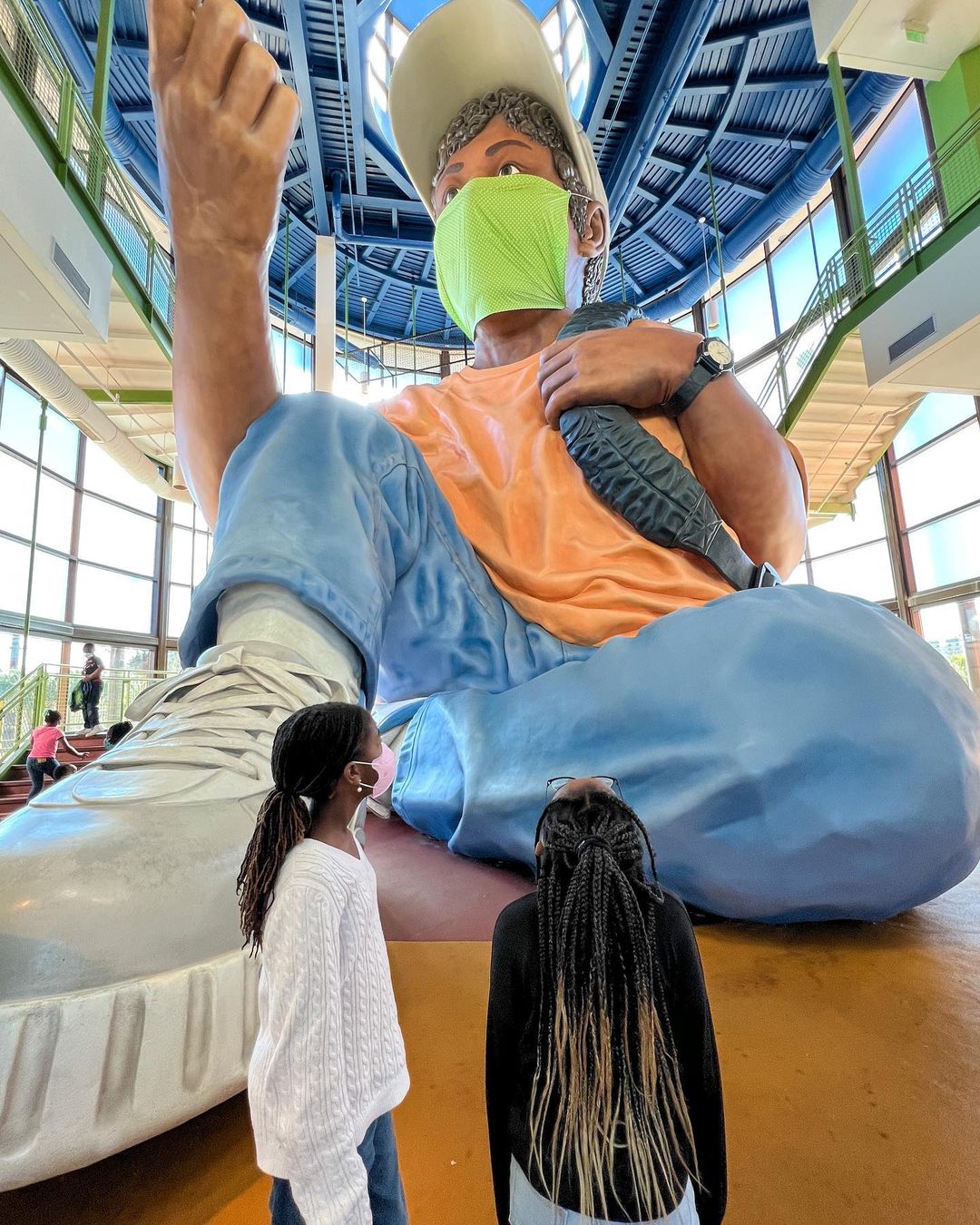 Two children stand in front of the "World's Biggest Kid" statue at EdVenture Children's Museum in Columbia, SC. Image by Instagram user @thespringbreakfamily.