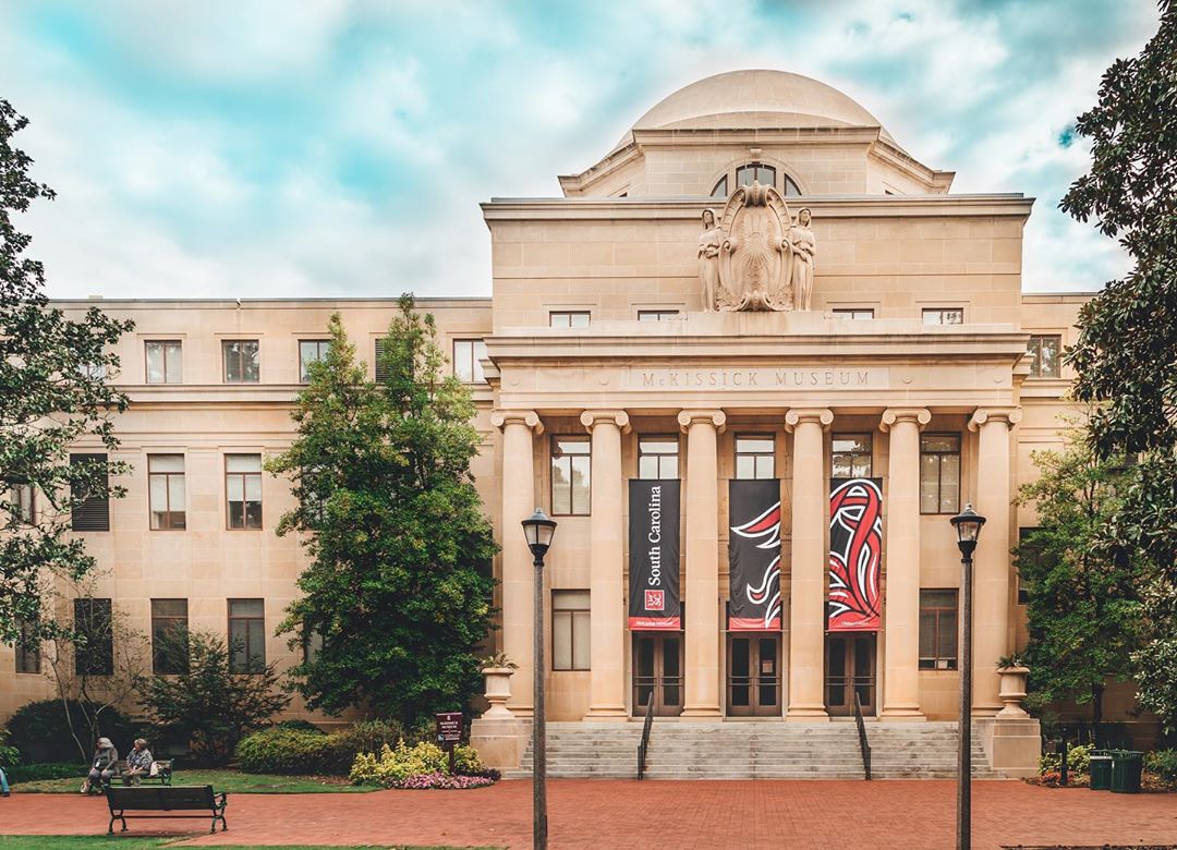 Tan building with pillars at University of South Carolina. Photo by Instagram user @uofsc