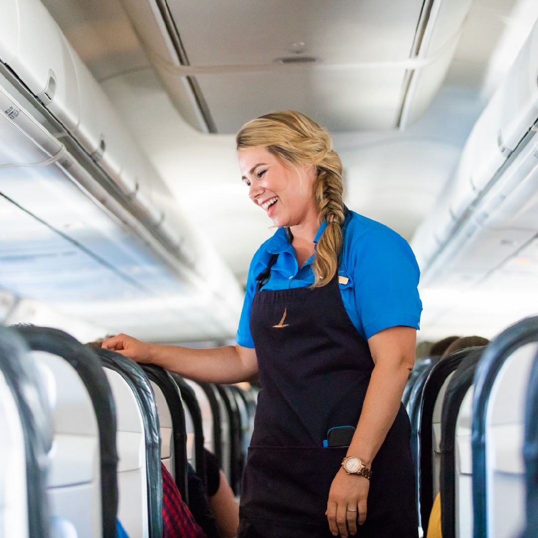 Flight attendant talking to passengers. Photo by Instagram user @alaskaair