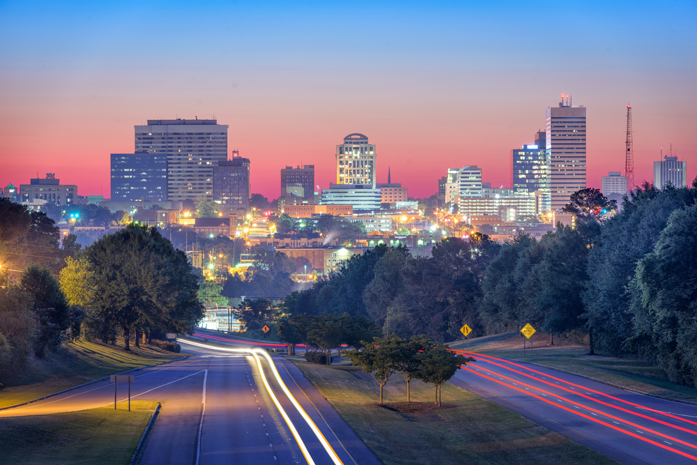 Skyline of tall buildings with lights on at night time in Columbia, SC.