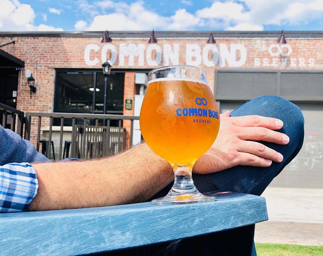 Beer glass on arm on chair. Photo by Instagram user @commonbondbrewers