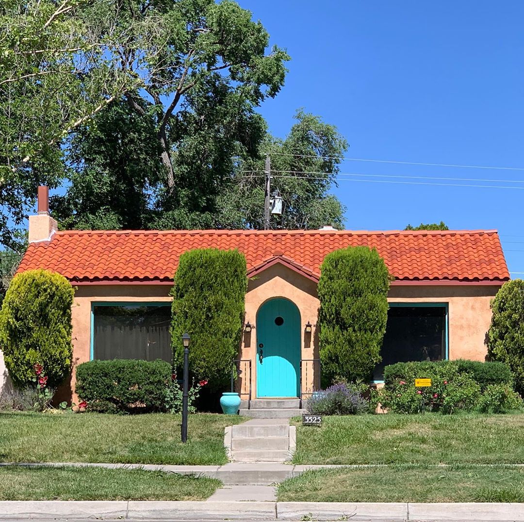 Orange house with red roof and turquoise door. Photo by Instagram user @jillrmeyers
