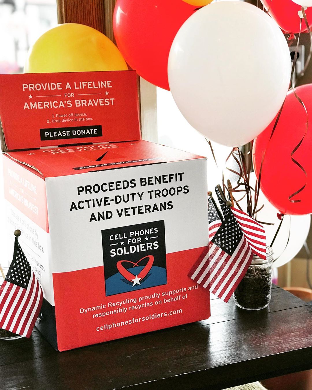 Red box by balloons for electric donations. Photo by Instagram user @amackswell