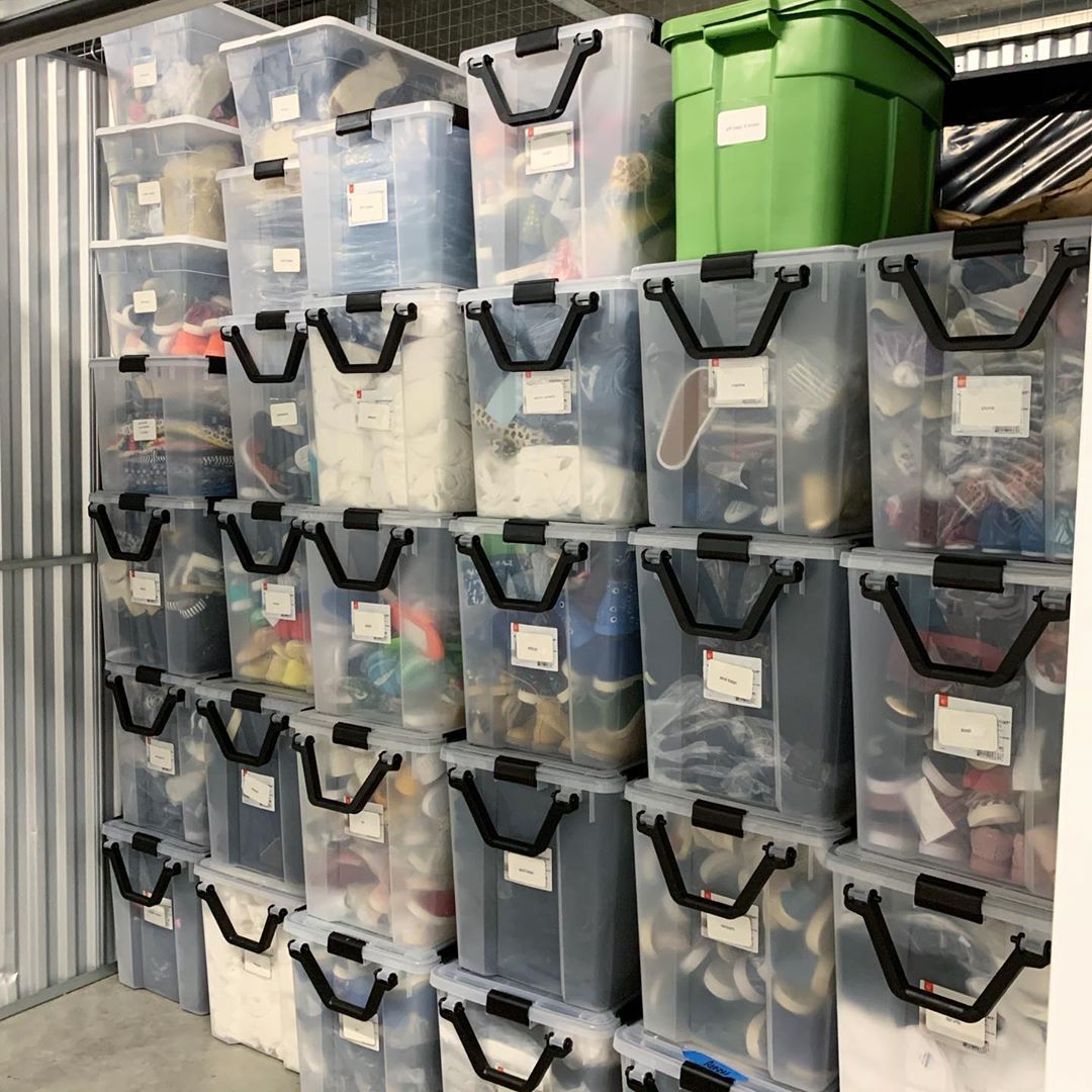 Clear storage bins in a storage unit. Photo by Instagram user @open4organizing
