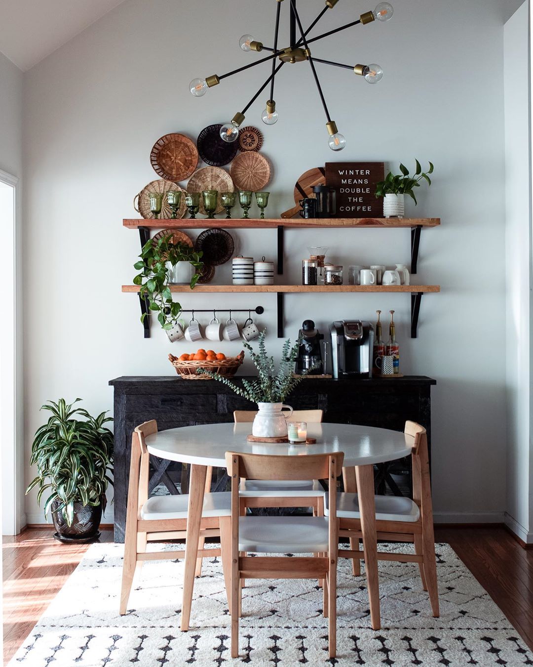 Dining room with white rug and white table with four chairs. Photo by Instagram user @fromgrittopearl