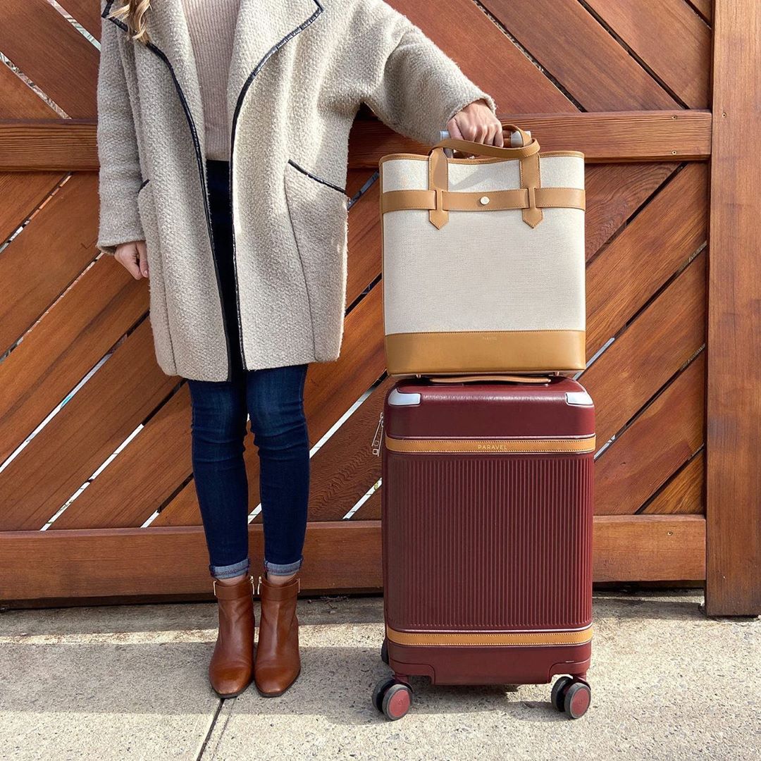 Girl standing next to packed suitcases. Photo by Instagram user @paravel