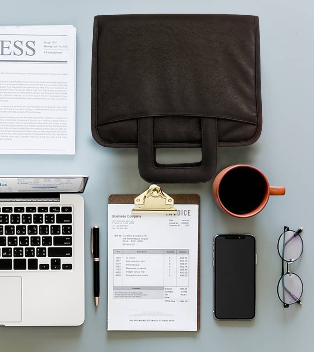 Table organized with coffee, briefcase, and computer. Photo by Instagram user @lust_leather