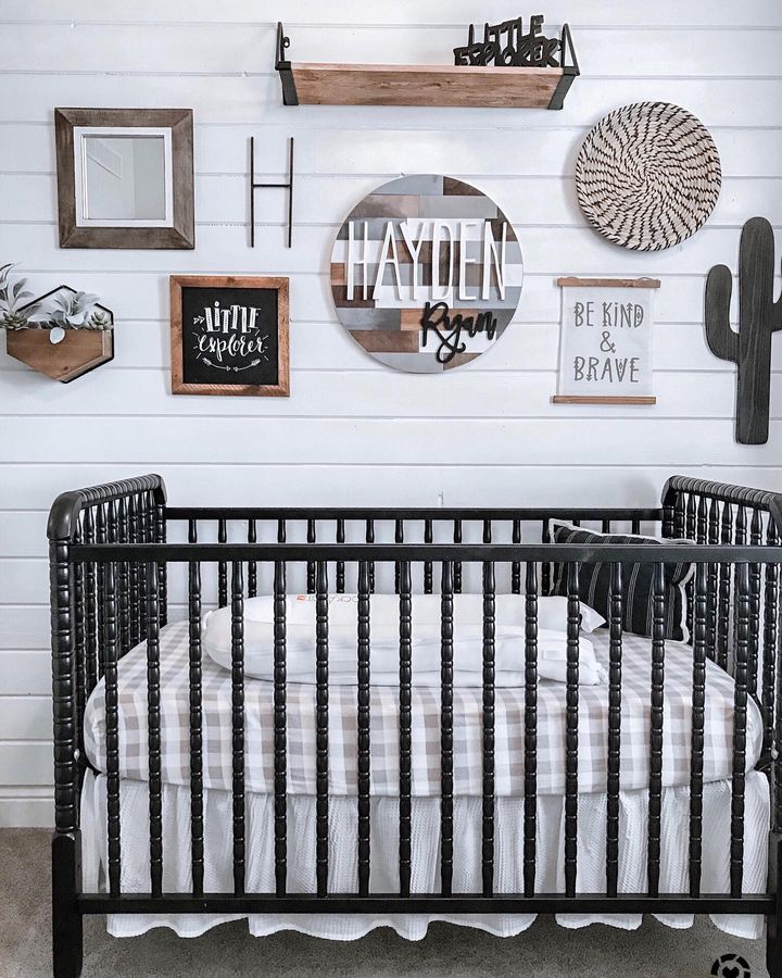 A white baby room with a gallery wall above the crib. Photo by Instagram user @mymodularfarmhouse
