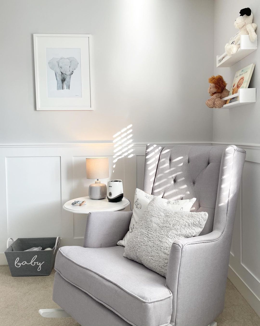 A baby room with a gray nursery chair. Photo by Instagram user @jessicalouise.home