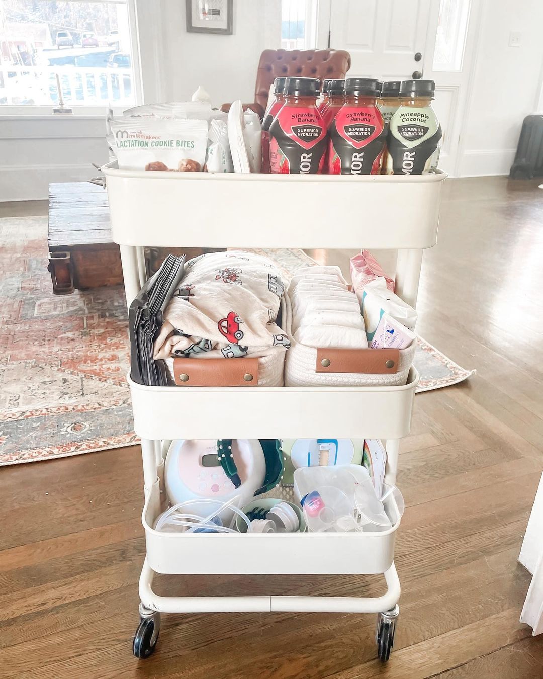 A rolling diaper station with various baby supplies. Photo by Instagram user @thathouseonmainstreet.