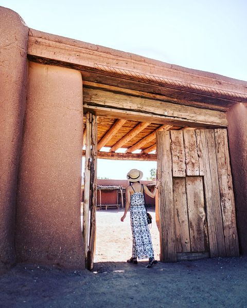 Person walking through doorway at El Rancho de las Golondrinas. Photo by Instagram user @cityofsantafe.