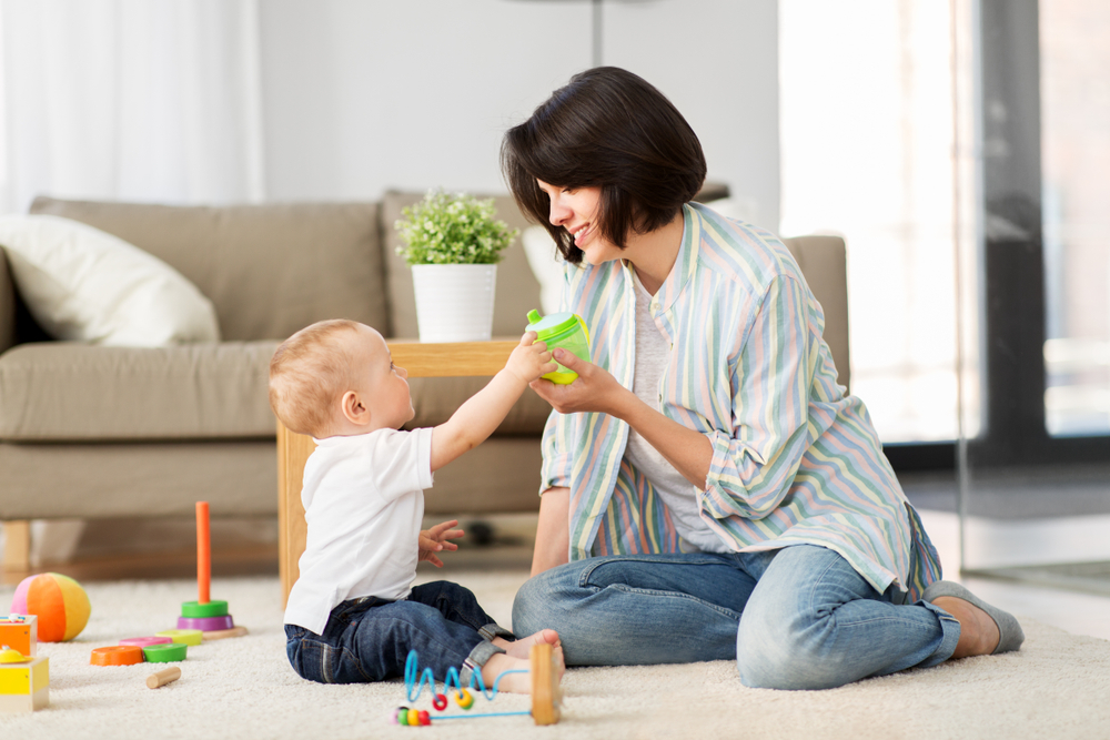 Mom playing with baby in living room