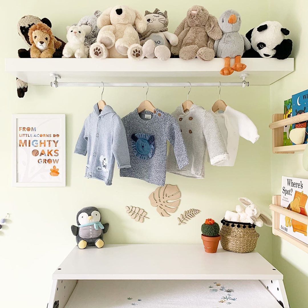 baby room with floating shelf with stuffed animals on top and clothes hanging photo by Instagram user @littleterracedhouse