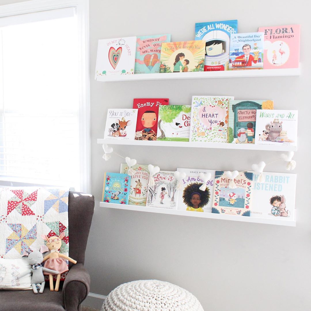 gray wall with small bookshelves installed and chair in corner photo by Instagram user @leesieandpip