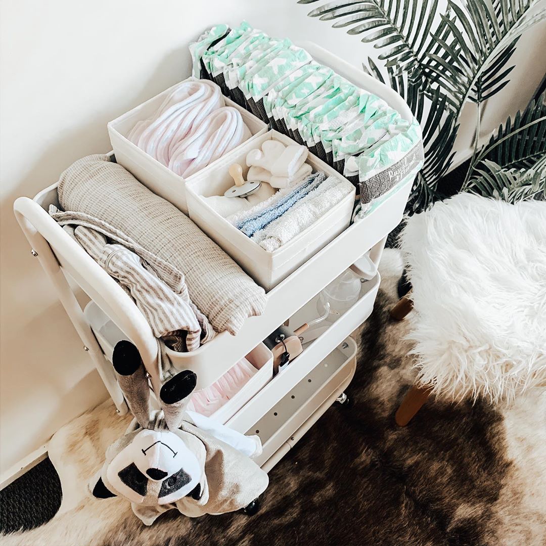 white diaper caddy with extra diapers and stuffed raccoon photo by Instagram user @__whiteathome