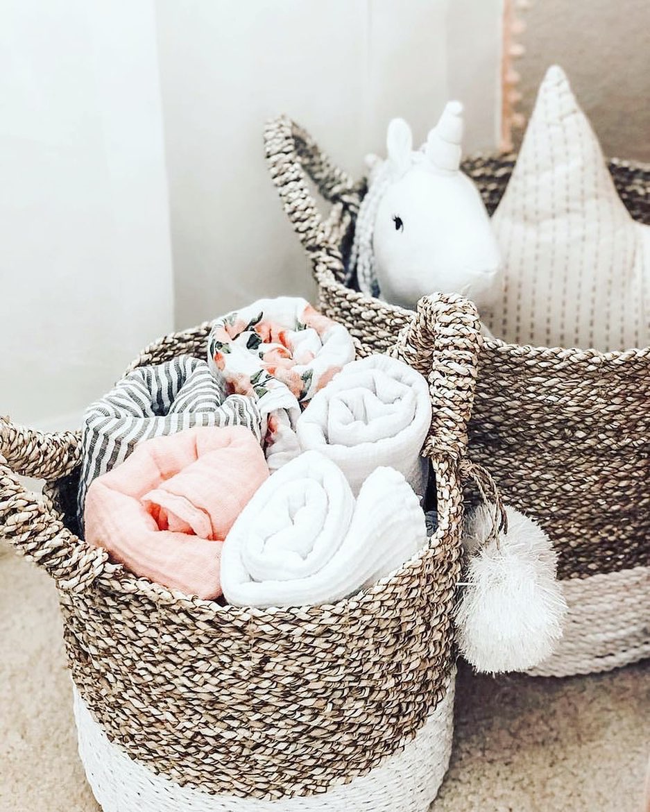 woven baskets with baby blankets and stuff animals inside photo by Instagram user @mylittlehomeideas