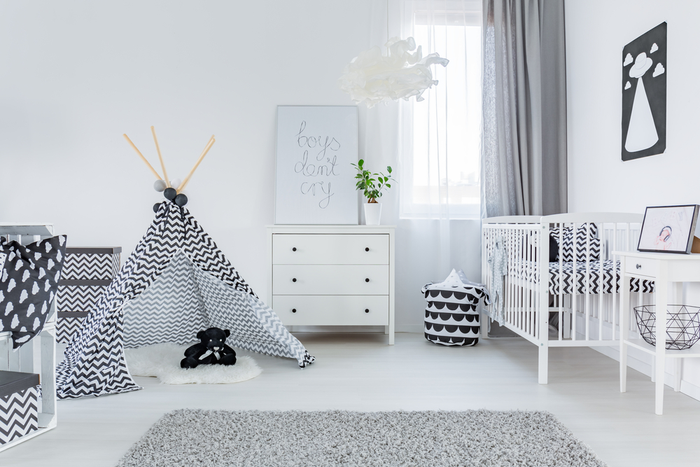 white baby nursery with small teepee and white crib