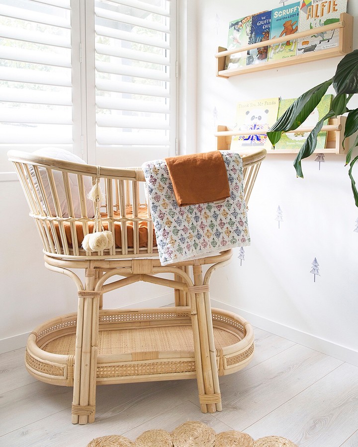 Wood bassinet in nursery corner. Photo by Instagram user @venitawilsonphotography