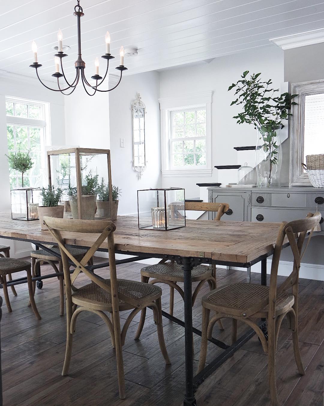 White dining room with wood table.
