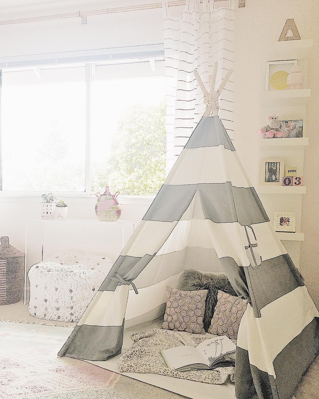 Nursery with gray and white tent. Photo by Instagram user @lindsaysaccullointeriors