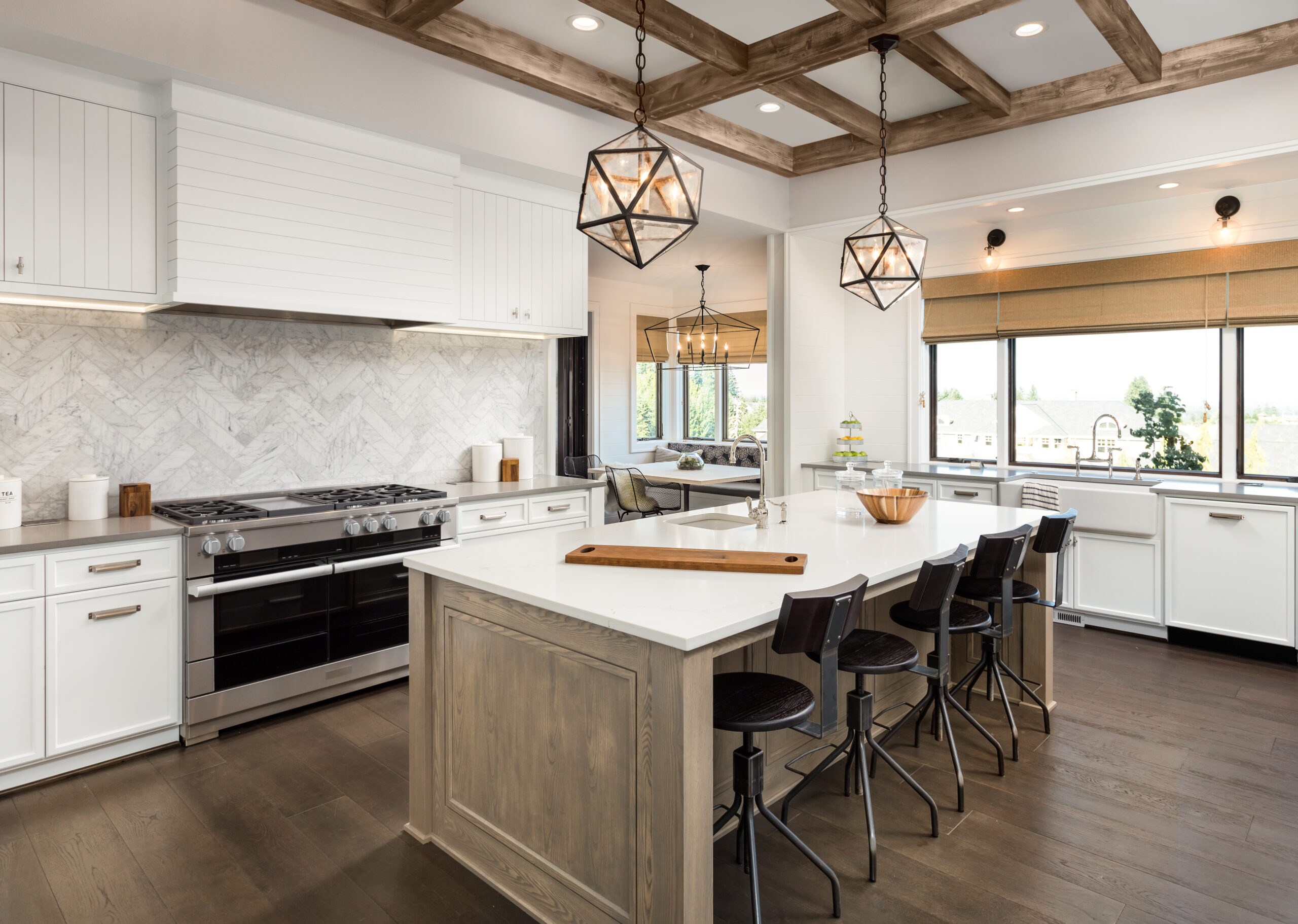 Farmhouse style kitchen with all white cabinets and hardwood floors.