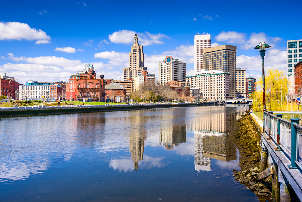 Skyline of Downtown Providence RI from the Providence river with blue sky and clouds