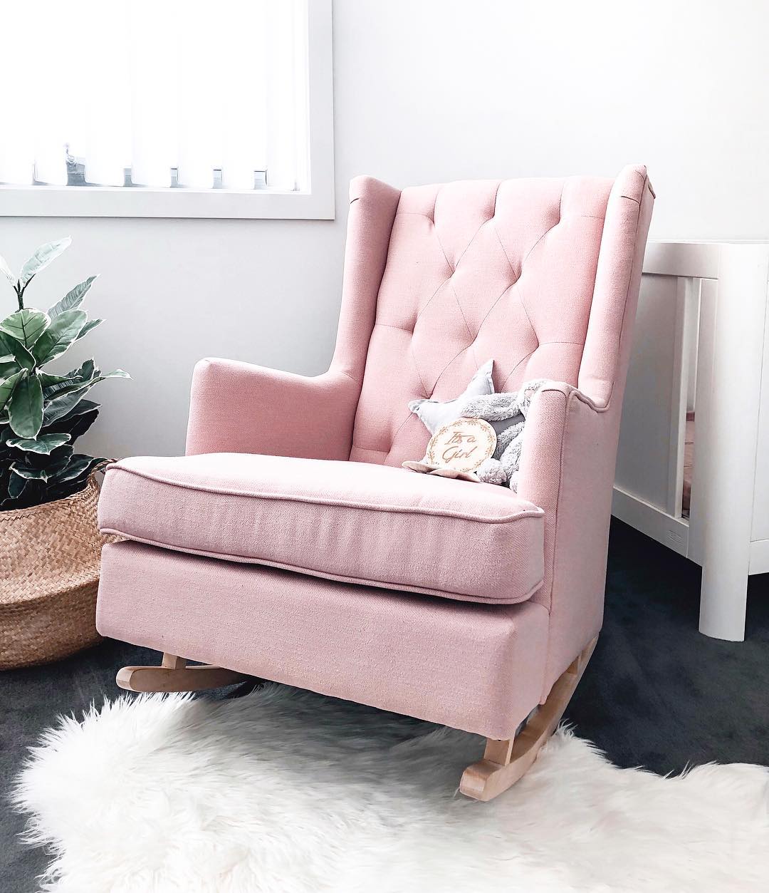 Pink rocking chair in nursery corner. Photo by Instagram user @mamaplusthree_
